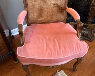 Matching pair of pink arm chairs with cane backs