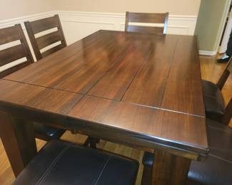 PRESALE ITEM $500- LIKE NEW BARELY USED-ASHLEY COUNTER HEIGHT TABLE WITH BUTTERFLY LEAF INCLUDES 6 COUNTER HEIGHT CHAIRS (THIS TABLE ALONE CURRENTLY LISTED NEW ON LINE FOR $450 PLUS TAX) ALSO INCLUDES TABLE TOP PROTECTOR