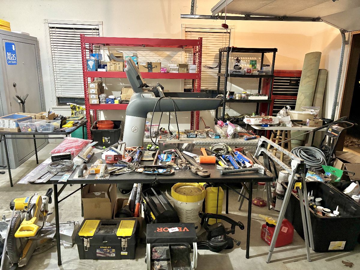 Mechanical and fitness assets, headlined by a commercial-grade Life Fitness treadmill and a large Atlas Safe Room steel vault. The workspace is anchored by a DeWalt compound miter saw and a comprehensive collection of hand tools, including various pipe wrenches, hammers, and carpentry squares. Storage solutions include a heavy-duty Stanley FatMax rolling project center and a red industrial-grade bulk racking unit, making this a prime selection for contractors or home workshop enthusiasts.