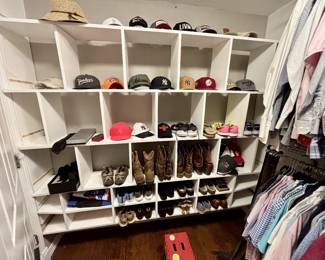 The collection is headlined by several pairs of leather western boots and various athletic sneakers (including Nike and Under Armour). The top shelves feature an impressive array of ball caps from popular brands and sports teams, including Yankees, Patagonia, Yeti, and Arkansas themed hats. Also included in this lot are casual loafers, dress shoes, and a straw sun hat, representing a wide-ranging selection of branded apparel in excellent condition.