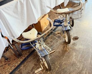 Two vintage tricycles with baskets