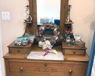 Victorian Eastlake-style chest of drawers with a carved mirror and marble top