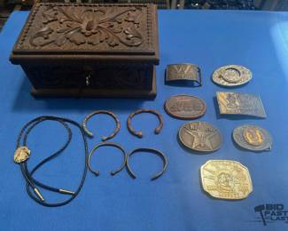 2010  7 Belt Buckles, 4 Metal Bracelets, 1 Bolo Tie, and 1 Wooden Trinket Box