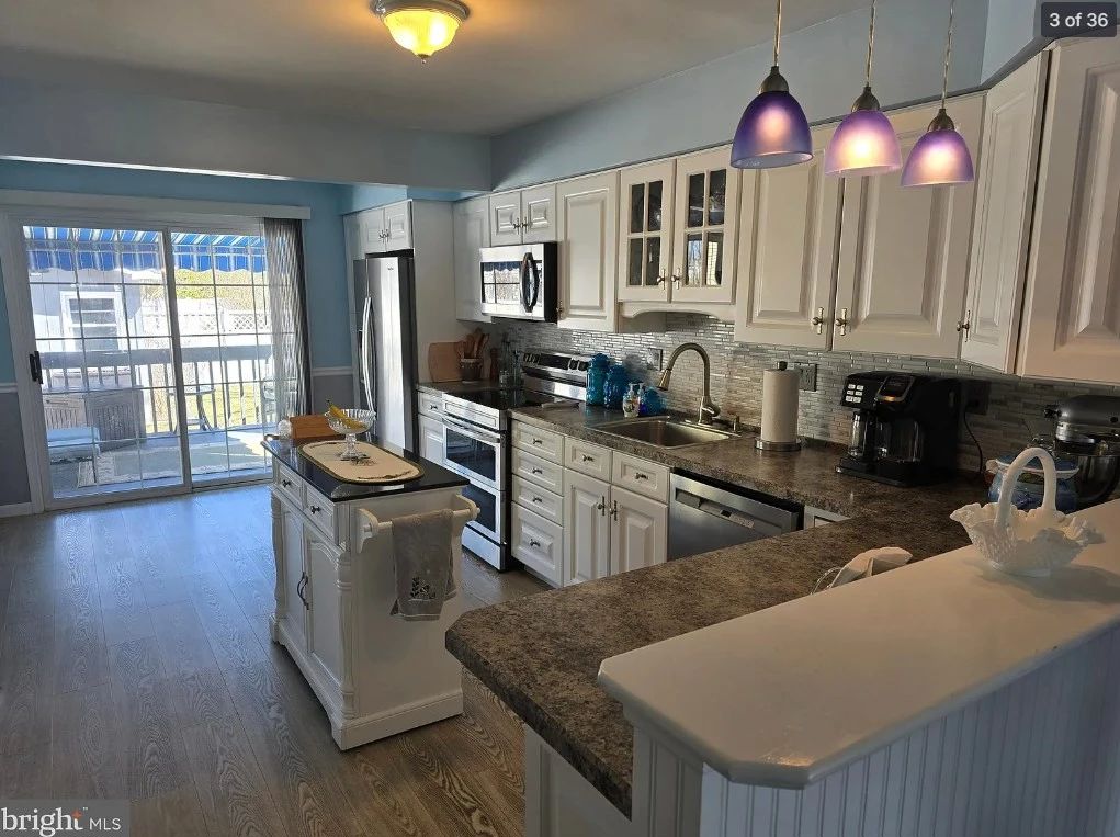Cute white kitchen with nice cabinets