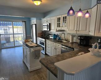Cute white kitchen with nice cabinets