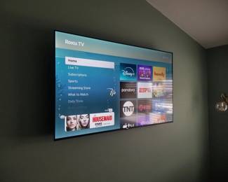 Flat screen smart TV with wall bracket