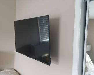 Flat screen smart TV with wall bracket