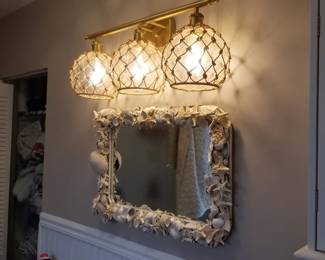Vanity light fixture; shell mirror