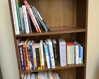 brown bookcase with books & paper