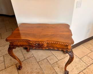We originally bought with $1200.   Antique mahogany tea table has a scalloped top with a carved rope edge. This American Chippendale style piece features a central shell carving on the apron and four cabriole legs ending in claw-and-ball feet. The wood has a rich grain pattern throughout.  Estimated (WxDxH): 38 x 24 x 29 in
