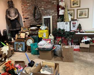 This photo shows another view of the same room and has a Santa with a cooking apron (gingerbread cookies anyone?), more holiday decor, framed artwork, a Regulator wall clock, a two-cat statue, several framed artworks, a fluffy brown/white/black area rug, and so much more.