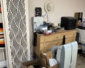 There are several interesting items here: the multi-panel room separator, the two hats, the Sharp branded...portable A/C unit?, two LED Disco Light units, a 50th Anniversary edition of Clue, and lots more.  I think I see a vintage cast iron clothes iron.  Maybe you could use it in a life-sized game of Monopoly?