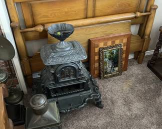 Here you can see a chessboard that needs some TLC, a bed headboard and footboard, and a decorative cast iron space heater?