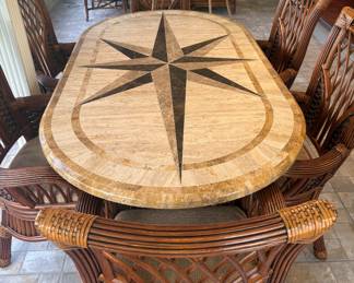 Southern Lifestyles nautical star inlay stone table with 6 rattan captain's chairs. Table measures  76"L / 42"W / 29.5"H.  Each chair measures 28"W / 18.5"L / 42"H