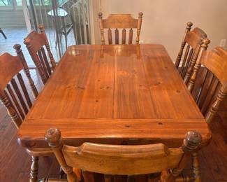 Solid pine dining room table with six chairs 63.5"L / 42"W / 20.75"H. Extendable by 24". Comes with table,  6 chairs, two leaves and table pads for protection. 