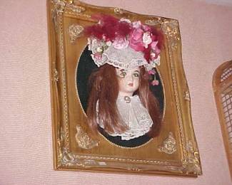 Creepy 3-D framed doll picture thing.