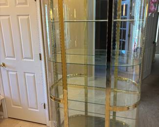 Hollywood Regency Style Brass is and Bowed Front Glass Curio $1,800.00. 4 shelves and lighted  42”W 16”D 77.5”T