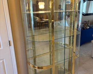 Hollywood Regency Style Brass is and Bowed Front Glass Curio $1,800.00. 4 shelves and lighted  42”W 16”D 77.5”T