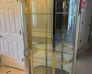 Hollywood Regency Style Brass is and Bowed Front Glass Curio $1,800.00. 4 shelves and lighted  42”W 16”D 77.5”T