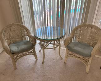 3 piece White Wicker Bistro Set $350.00.  Chairs: 29”W 19” D 34” T holds Table: 30” diameter 28”T glass top