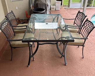 Aluminum Patio dinning table and 4 chairs $350.00.  Table: 68”L 40”W 29” T glass top w umbrella hole. chairs: 24.5”w 22”d 35”t