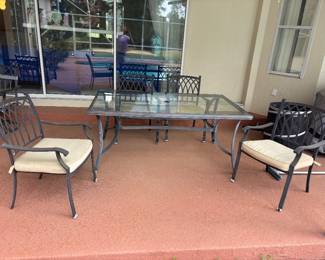 Aluminum Patio dinning table and 4 chairs $350.00.  Table: 68”L 40”W 29” T glass top w umbrella hole. chairs: 24.5”w 22”d 35”t