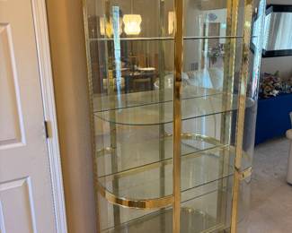 Hollywood Regency Style Brass is and Bowed Front Glass Curio $1,800.00. 4 shelves and lighted  42”W 16”D 77.5”T
