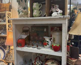 bookshelf, strawberry ceramic items, vintage plates, bunnies