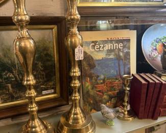 brass candlesticks, books, framed art