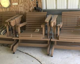 Several wooden glider chairs with cushions