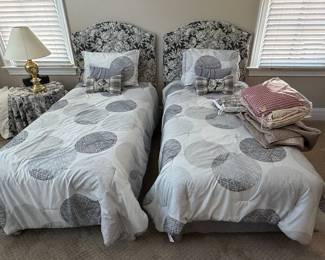 Pair of Twin Beds with Upholstered Headboards and Geometric Pattern Bedding