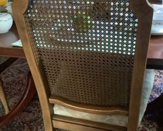Showing the cane back of the dining chairs.