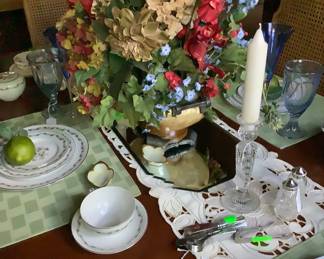 Close-up of the centerpiece in middle of table with crystal candlesticks, and fine China.  Has a pair of Waterford salt and pepper shakers.