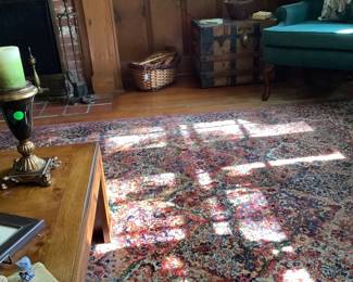 A large basket sitting by the fireplace.  There are several baskets available.