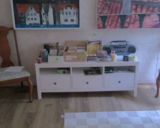 One of the cabinets in den with radio, games and other accessories.