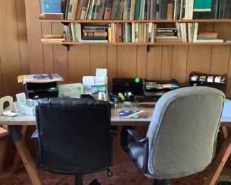 Several desks made out of work horses with lots of office supplies, and desk chairs.  Listen all you school kids and college students , this is the place to shop for supplies.