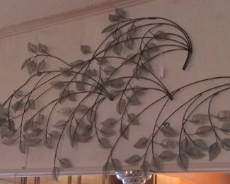 Beautiful metal wall hanging with green leaves.
