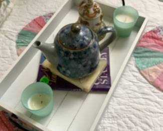 Tray on twin bed with blue candles ,books and beautiful bed to ring for your husband (ha) or housekeeper.  Has lovely teapot for your tea.  Sitting above a guilt with circles.