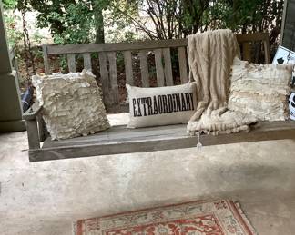 The pirch swing has several throw pillows and throw.  Sorry the swing goes with the sale of the house, but you are welcome to sit in it and enjoy.