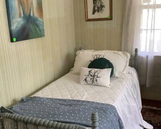 One of the twin bed, hand painted in Irish blue, comes with the mattress and box springs.  On dude of bed js a young lady in blue with her gown. Above each  bed are pictures with birds. Both beds also have throws .