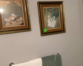Two beautiful pictures of swans in master bath.
