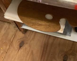 In the art room is a large roll of canvas, boxes of canvas.