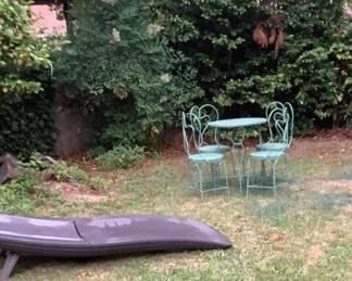 A newly painted green ice cream parlor table with 4 chairs.