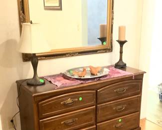 Chest with lots of drawers with gold and black mirror.