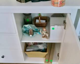 In other cabinet are doll heads, Barbie dolls.