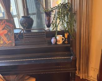 Dark Wood Upright Piano with Turned Legs and Decorative Music Desk