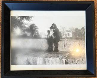$25, Black and White Film Photograph — Figure with Dog on Stone Ledge