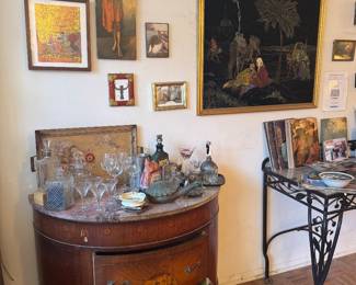 Demilune Cabinet Bar Setup with Assorted Glassware and Framed Art Collection