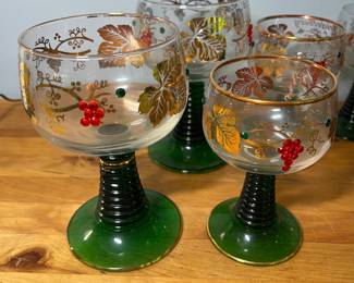 H51 - $75. 14 Pc. Vintage German Roemer Grape Vine. Gold Rimmed glasses. Beehive stem. 3" tall, 3.5" tall, 4.5" tall, 5.5" tall. ALL have noticeable wear on the gold trim. 