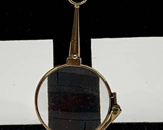 Lot 24	Collapsible Lorgnette with Round Lenses and Decorative Chain with Gold Embossed Leather Case (early 1900s). 14K Gold Chain, Leather.